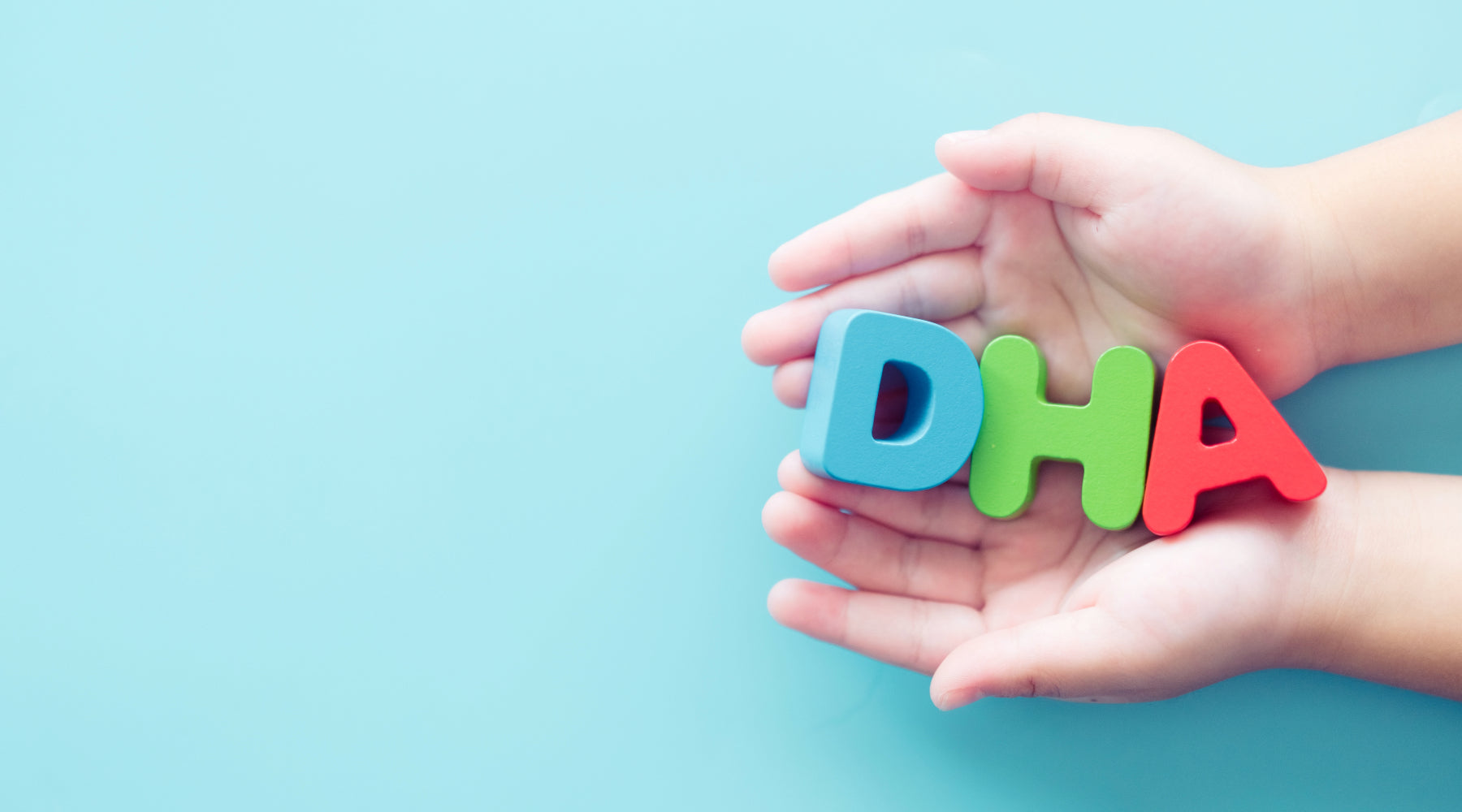 child holding the letters D H A